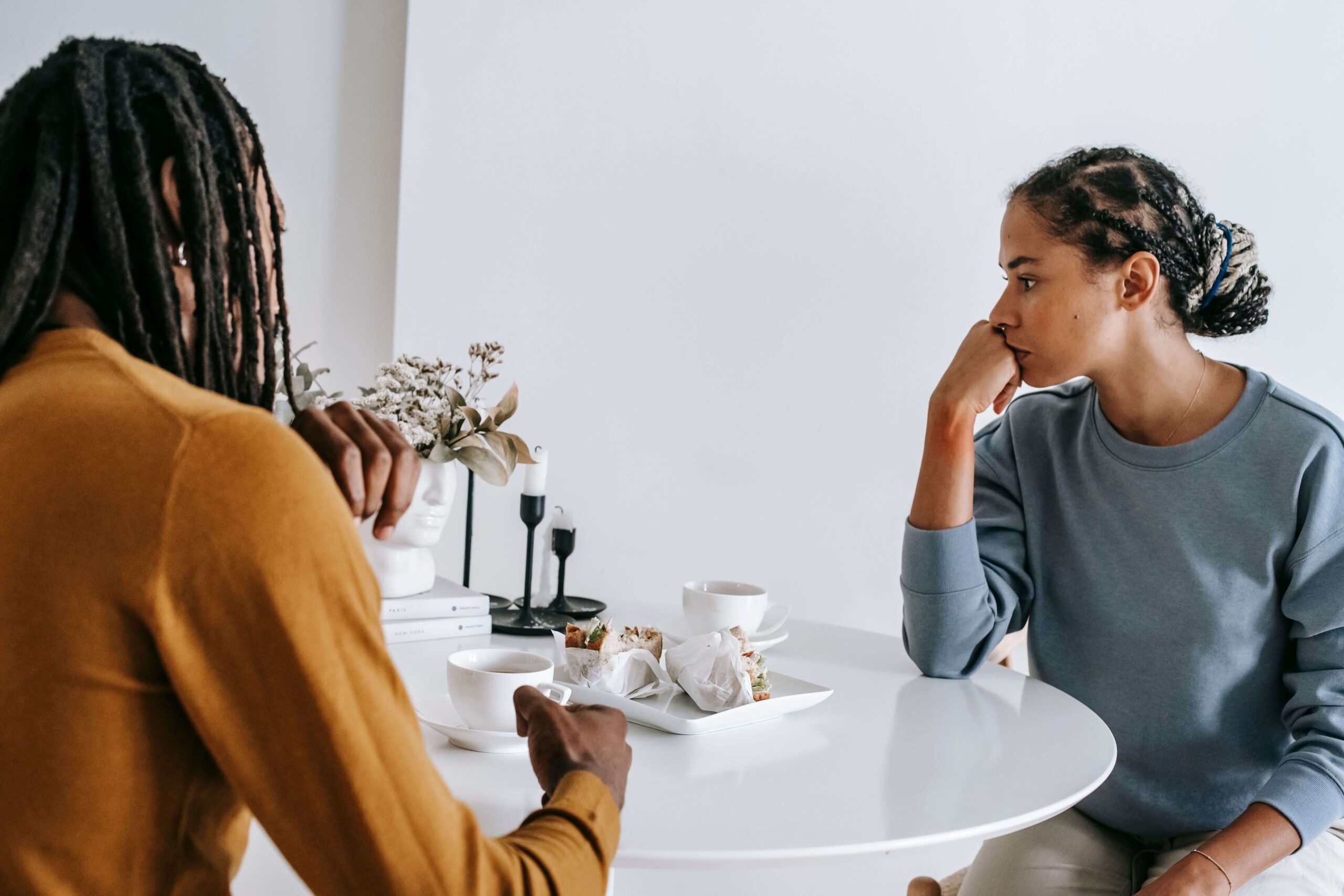 Woman appearing emotionally shut down while talking with her partner, representing communication challenges explored through individual relationship counseling in Denver, CO.