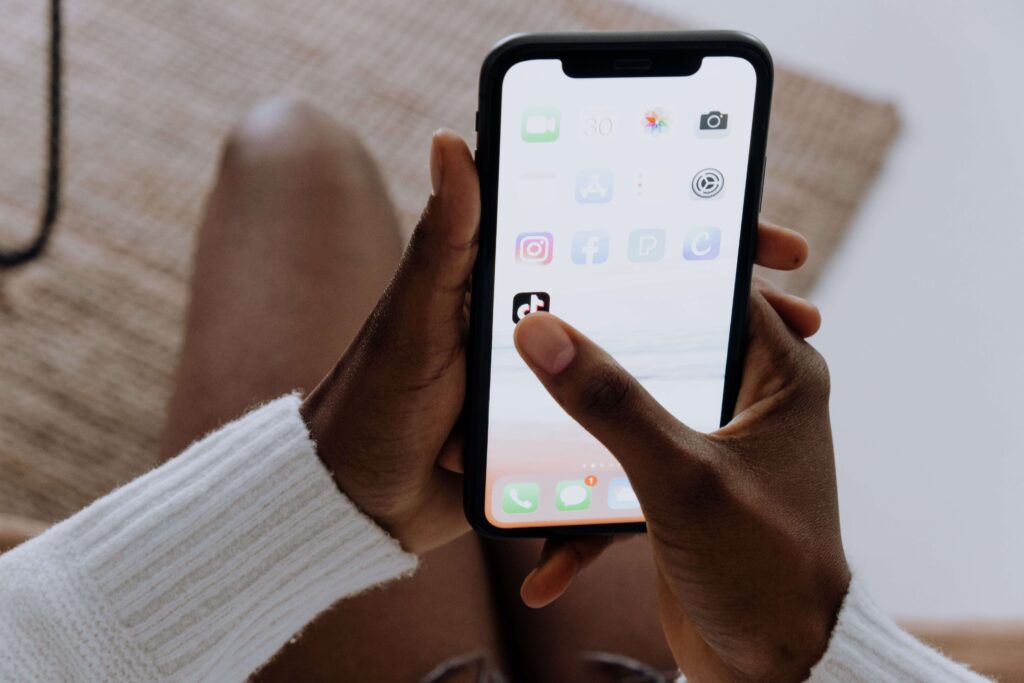 Person opening a social media app, reflecting how online content can contribute to relationship uncertainty in Denver, CO.