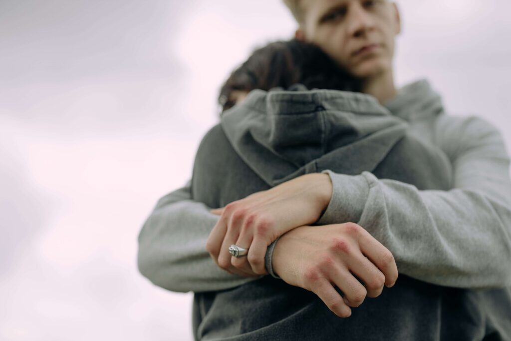 Close-up of a man hugging a woman, symbolizing emotional support, reassurance, and healthier validation in relationships in Denver, CO.