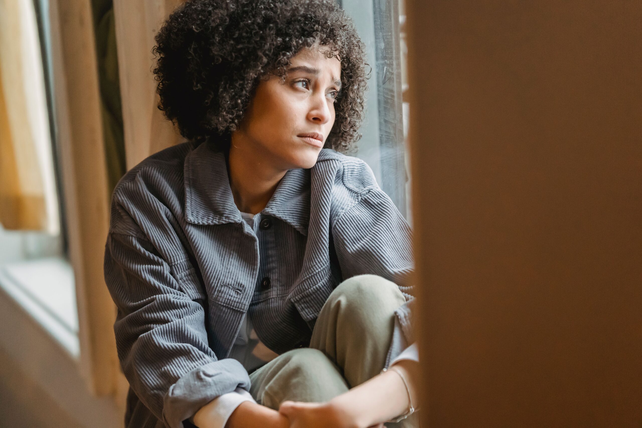 Fear of Being Alone - individual relationship counselor denver co - individual relationship counseling denver co - individual relationship therapist denver co - colorado Woman looking sad and reflective, representing the fear of being single and relationship concerns addressed by an individual relationship counselor in Denver, CO.