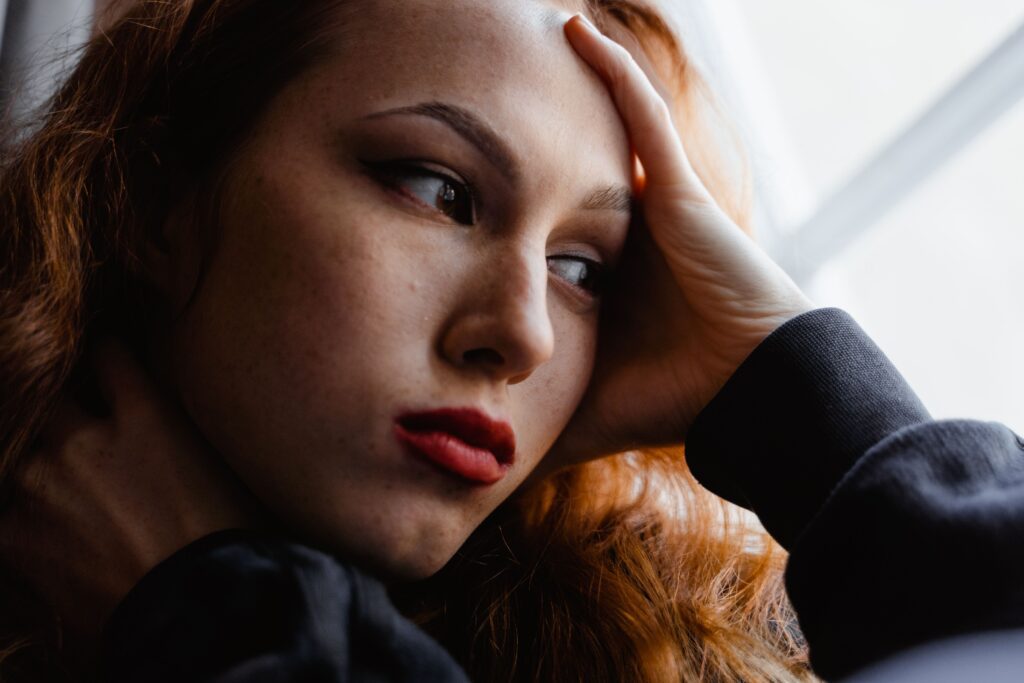 Reflecting on Self-Worth - therapy for validation in relationships denver co - individual therapy for relationships denver co - individual counseling for relationships denver co - colorado Woman looking thoughtfully out a window, representing self-exploration and emotional insight supported through individual relationship therapy for validation in relationships in Denver, CO.