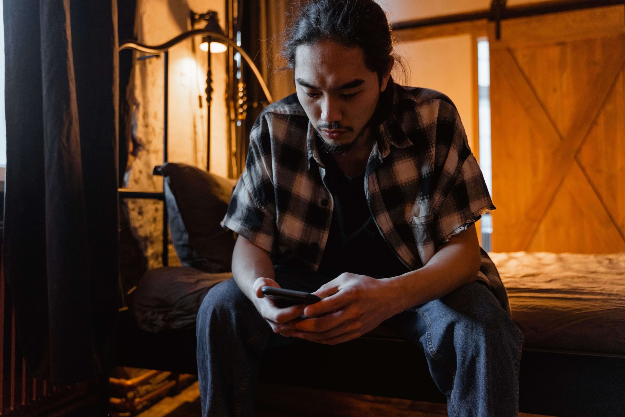 Person anxiously using an AI chatbot on a phone, reflecting relationship doubts and uncertainty explored through questioning your relationship in Denver, CO.