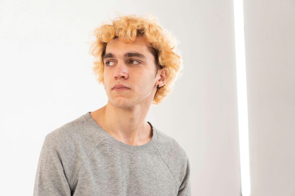 Man looking into the distance thoughtfully, representing relational processing explored in individual relationship therapy for men with autism in Denver, CO.