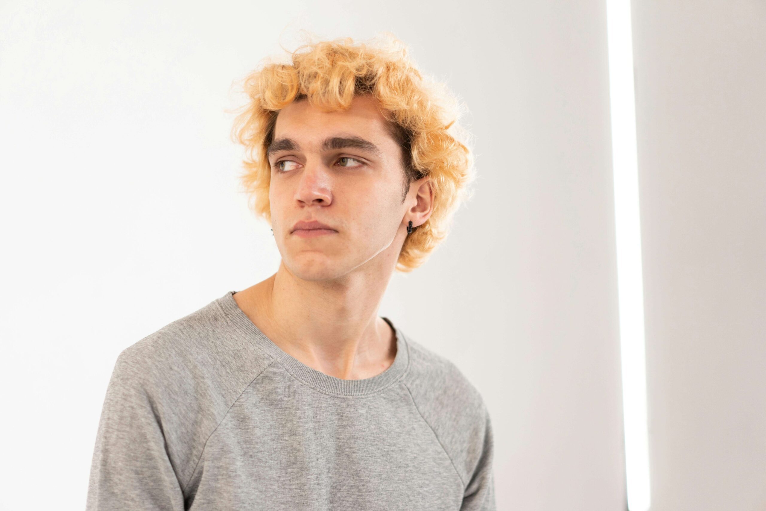 Man looking into the distance thoughtfully, representing relational processing explored in individual relationship therapy for men with autism in Denver, CO.