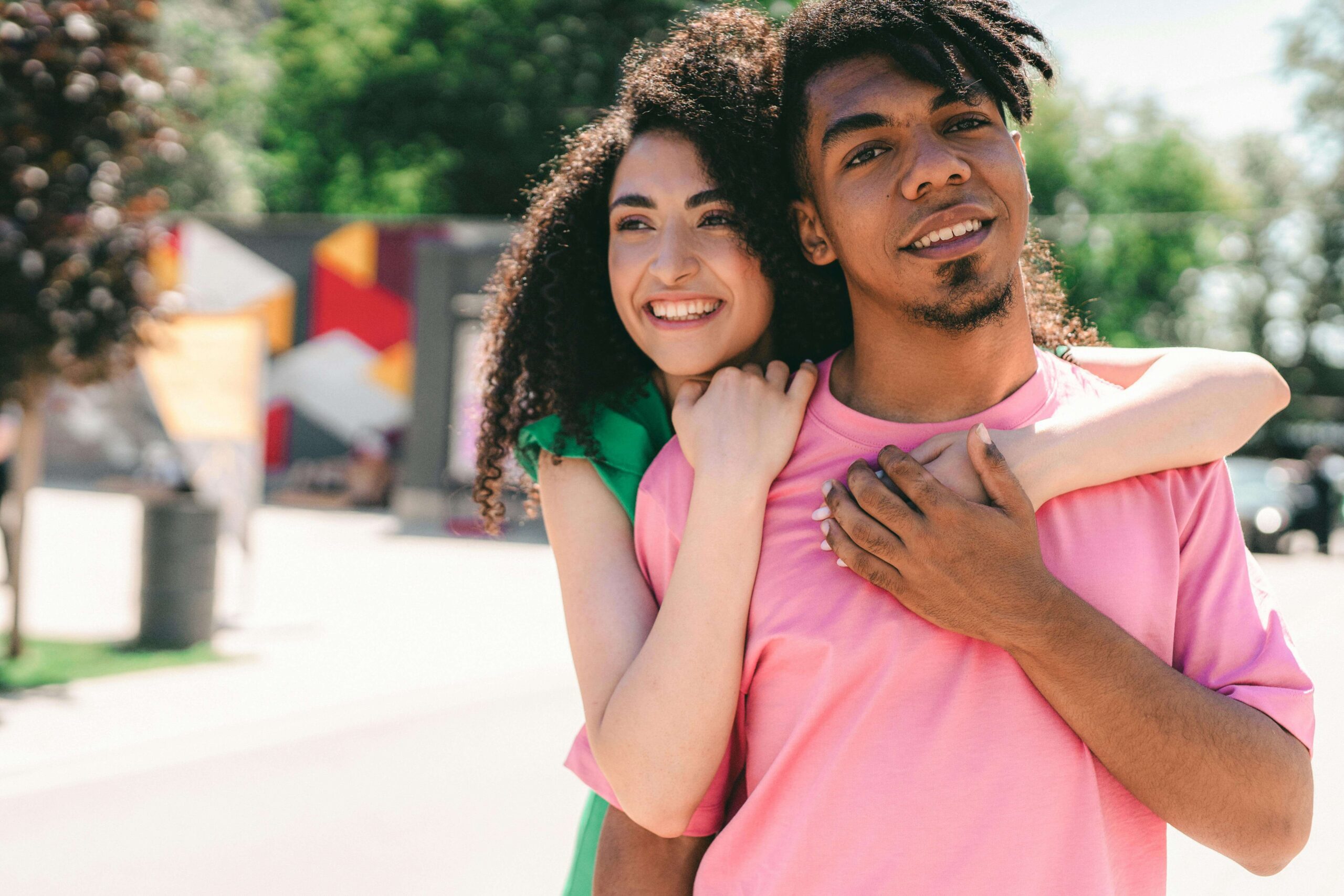 Man and woman smiling happily together, symbolizing improved communication and relationship growth supported through individual relationship therapy for men with autism in Denver, CO.